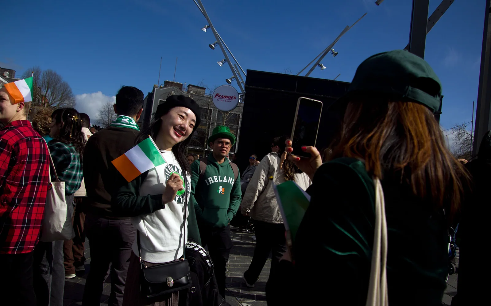 Spectators holding Irish flags during St Patrick’s Day celebrations in Cork