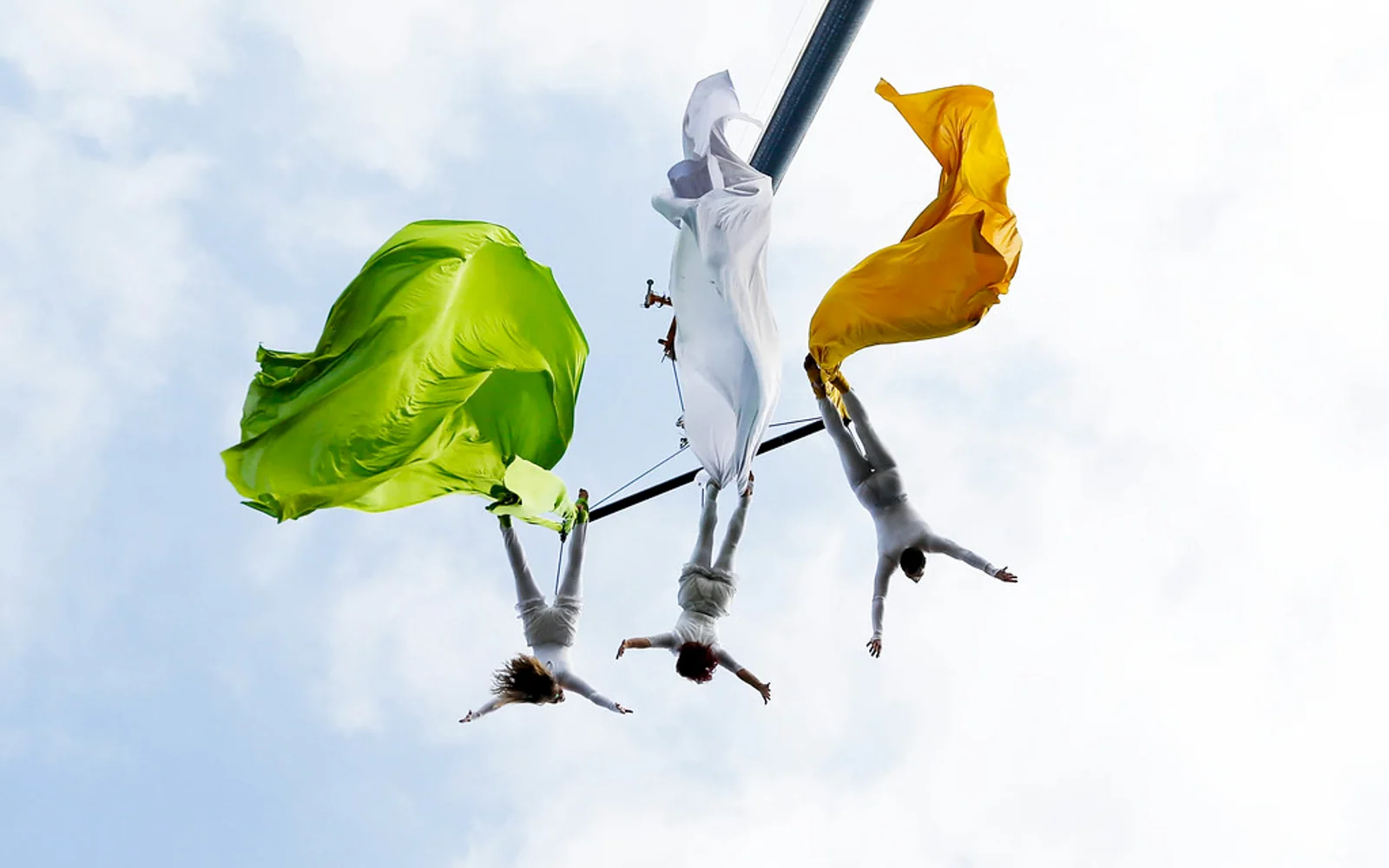 Aerial performers carrying Irish tricolour fabric at the St Patrick’s Day parade in Limerick