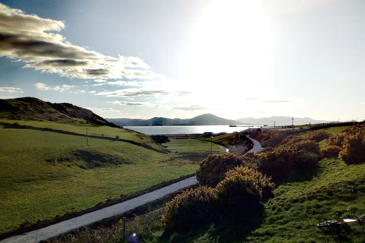 The coastal Tralee–Fenit Greenway winding through fields beside Tralee Bay