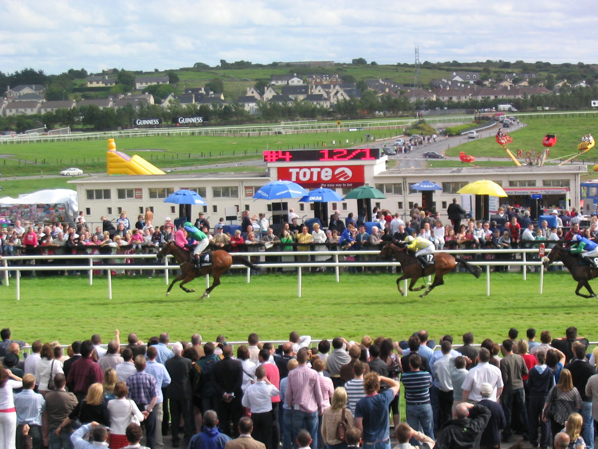 Racehorses passing the crowd at the Galway Races